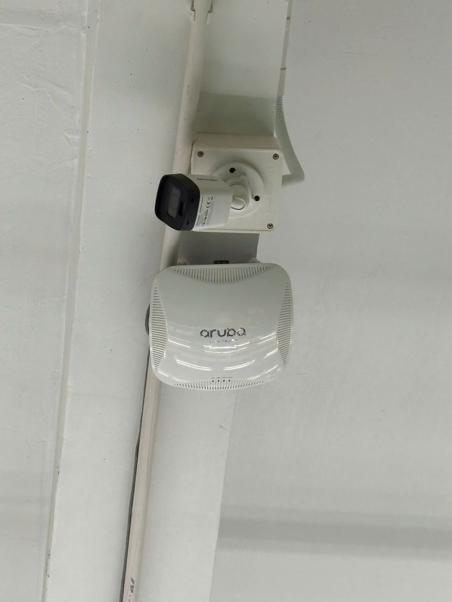 Thiết bị phát Wi‑Fi Aruba và camera sau khi lắp trên trần
